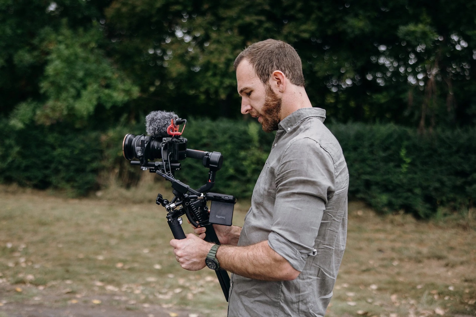 Kowen filming with a gimbal-mounted cinema camera among the trees